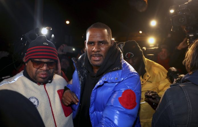 R. KELLY ARRESTED, CHARGED IN CHICAGO WITH SEXUAL ABUSE